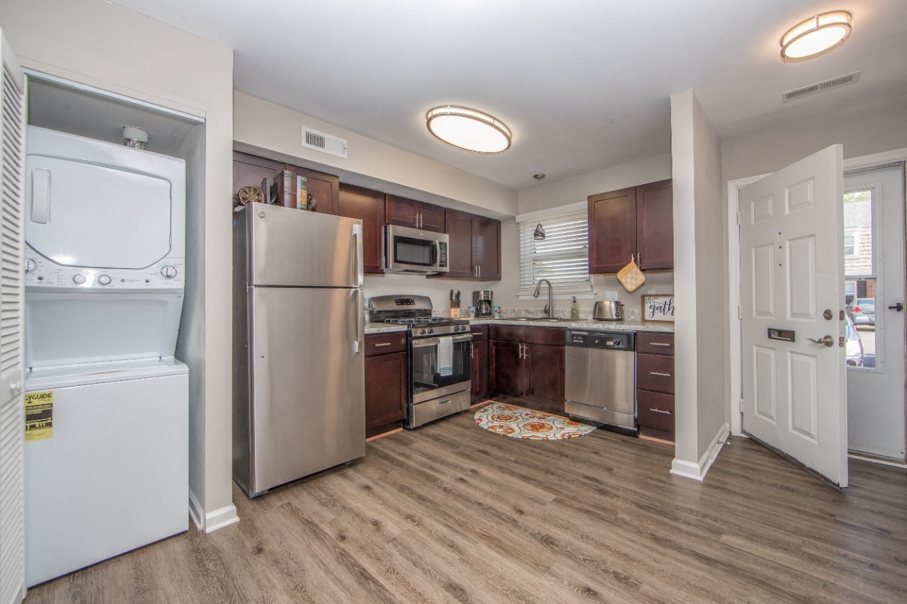 Stainless steel appliance kitchen and attached laundry closet at Villages at City Center apartments in Newport News VA