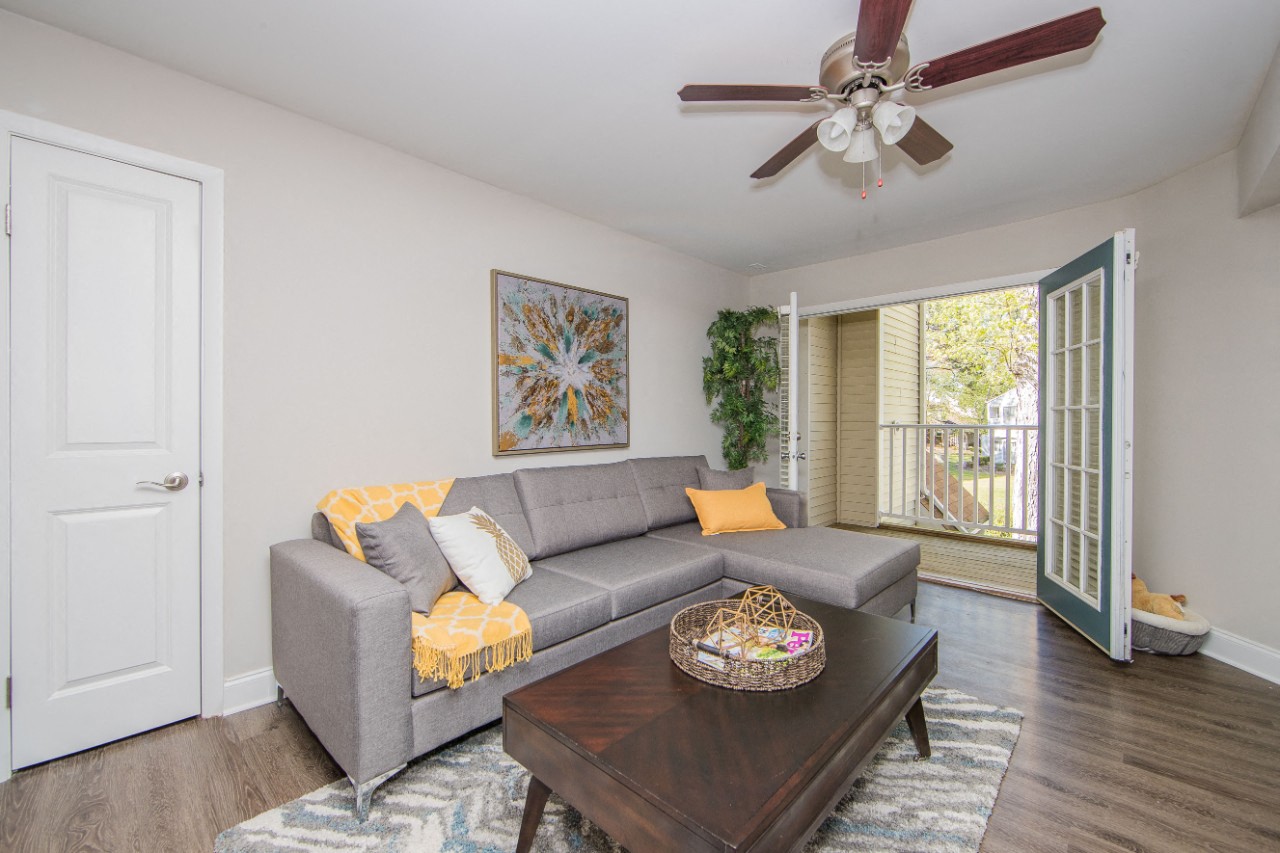 Living room with outdoor access at Villages at City Center apartments in Newport News VA