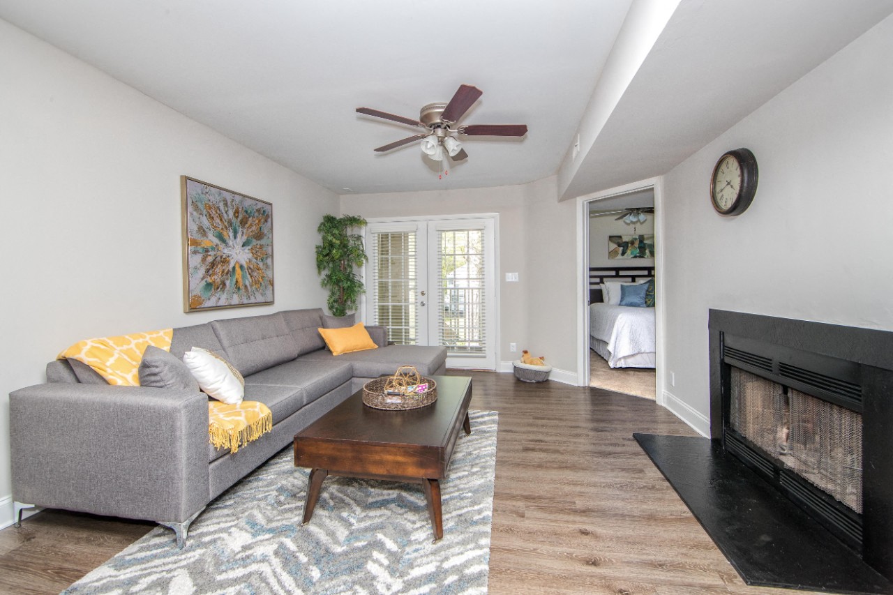 Living room with hardwood floor and fireplace at Villages at City Center apartments in Newport News VA