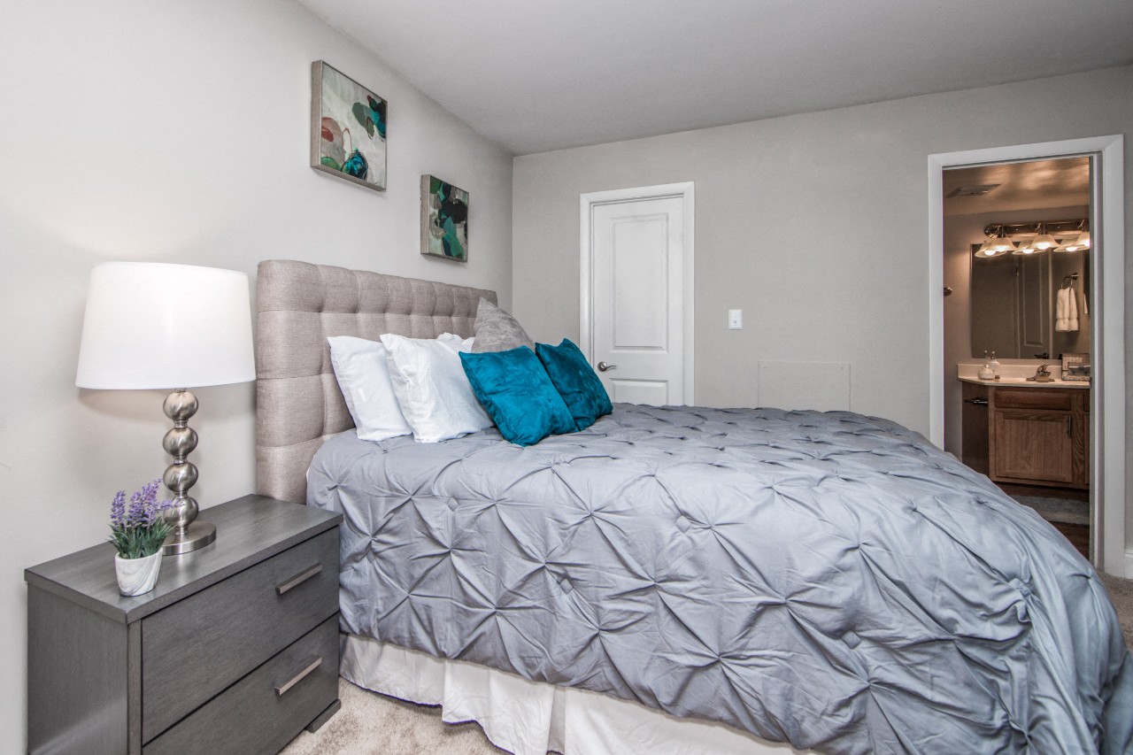 Bedroom with attached bath at Villages at City Center apartments in Newport News VA