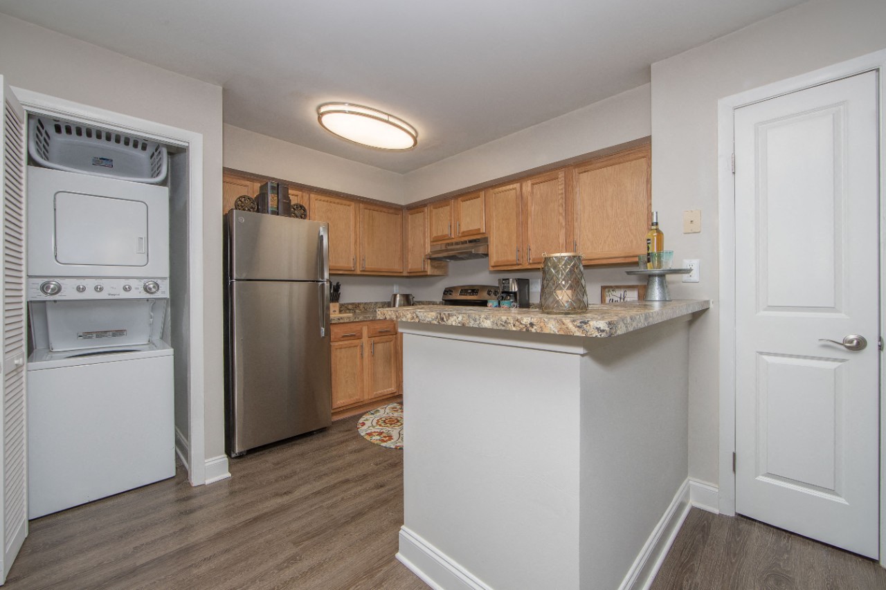 Stainless steel kitchen with granite counter at Villages at City Center apartments in Newport News VA