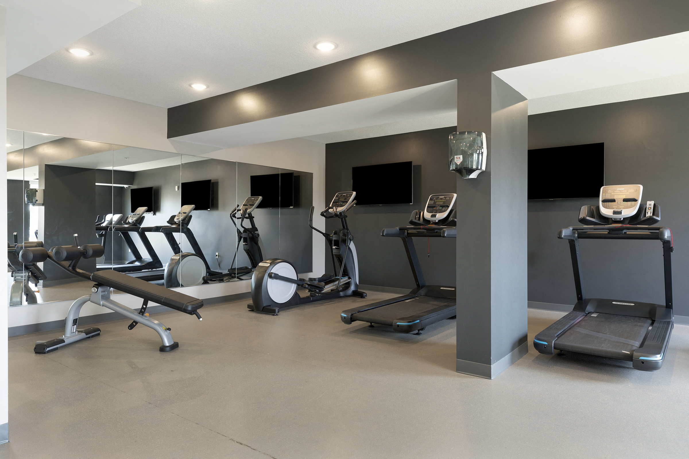 a gym with treadmills and other exercise equipment
