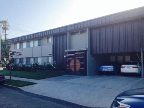 a large building with two cars parked in front of it