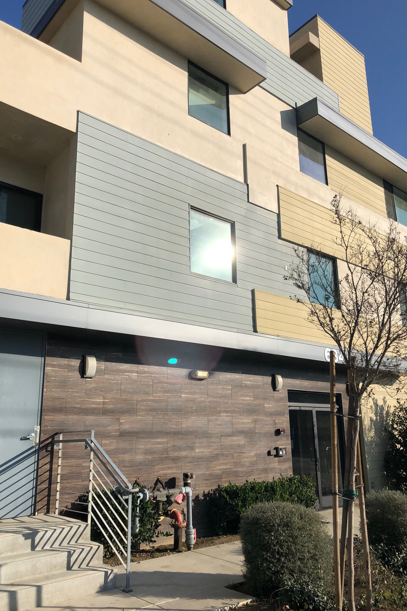 a large building with a staircase and a glass door