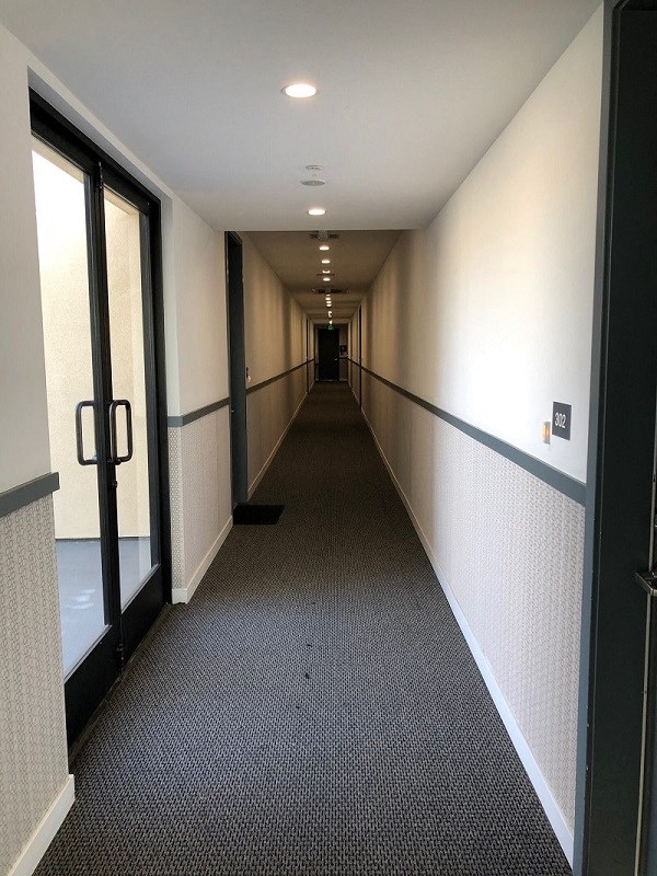 a hallway with doors and windows in a building