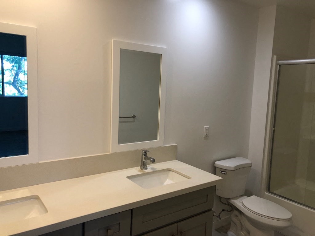 a bathroom with a sink toilet and a mirror