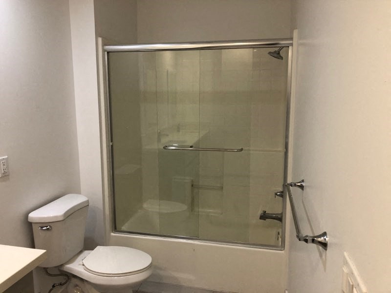a bathroom with a toilet and a shower