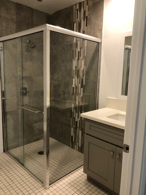 a bathroom with a shower and a sink