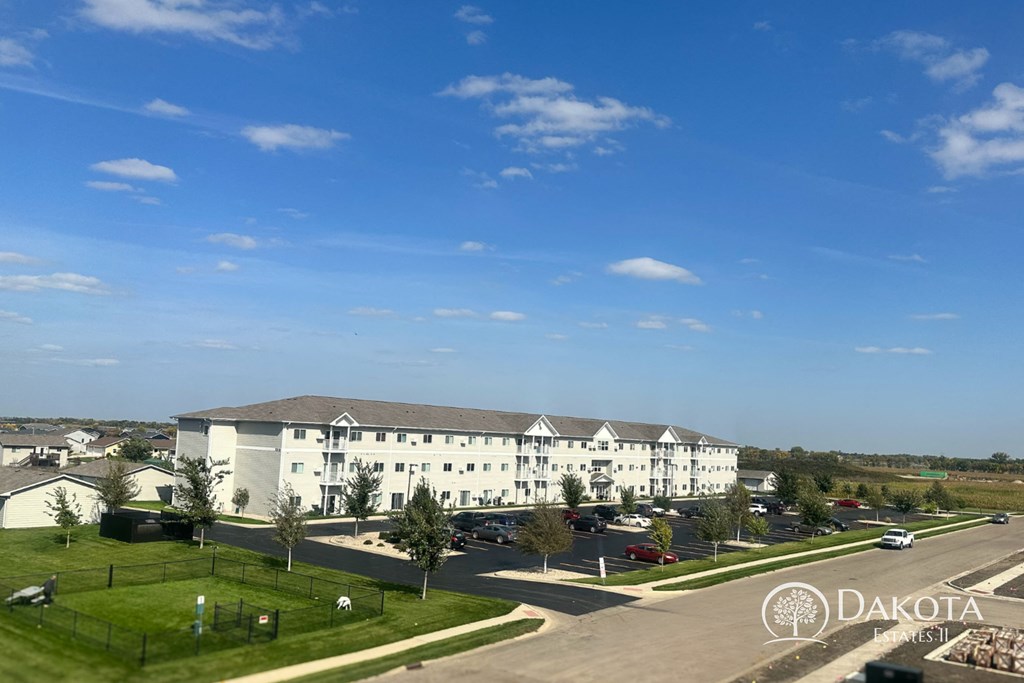 a large white building with a street in front of it