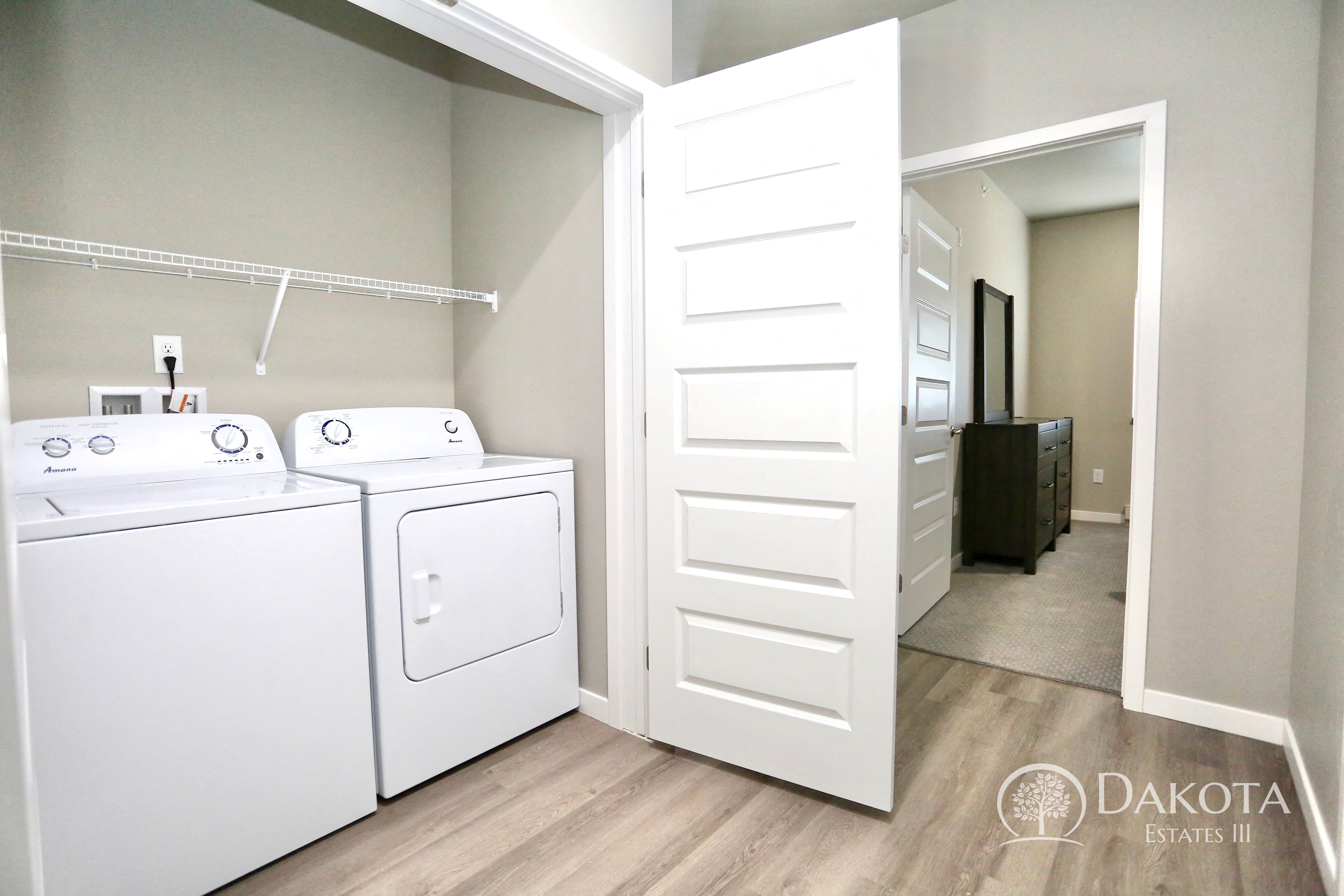 a laundry room with a washer and dryer and a closet with a door