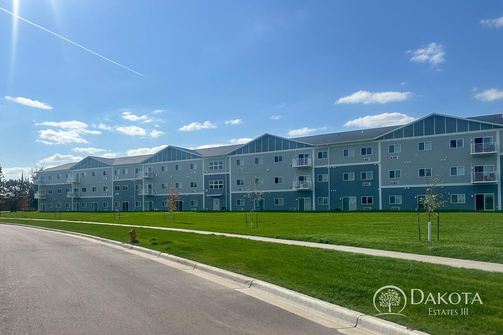 an apartment building on the side of a road