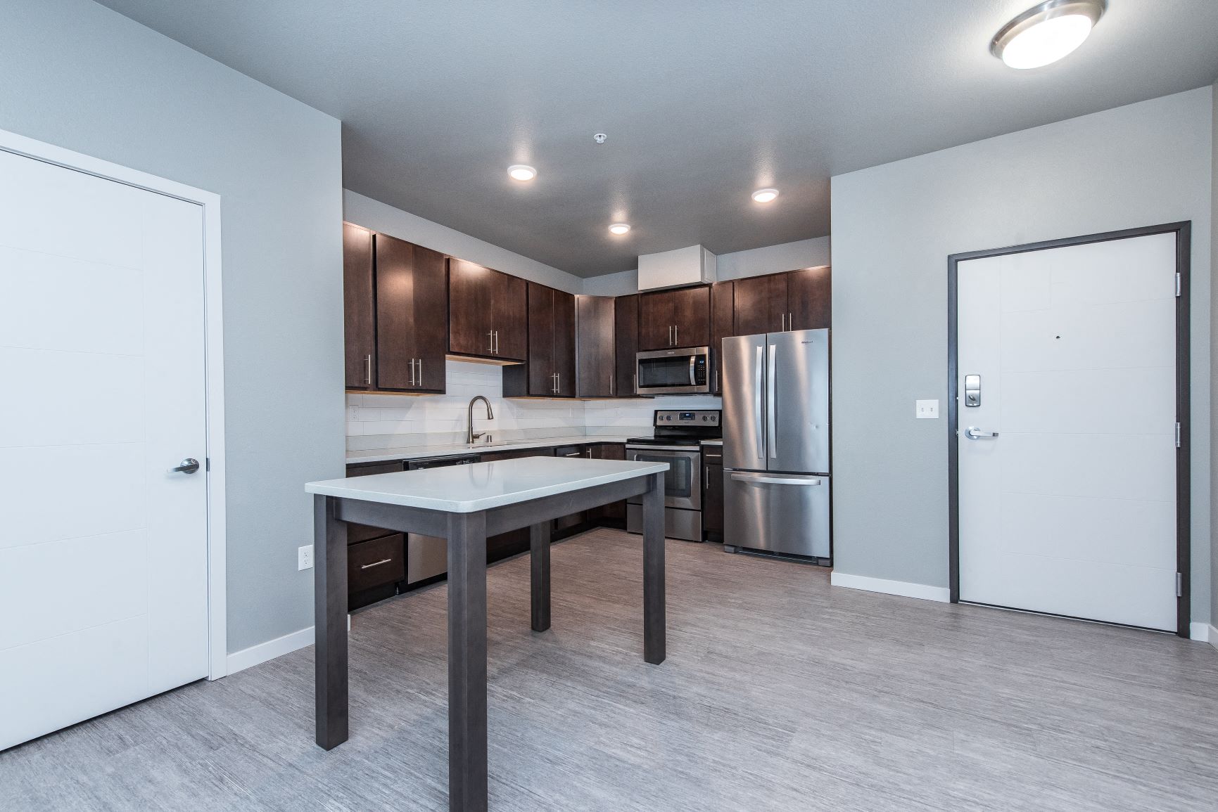A kitchen with a table and chairs in the middle of the room.