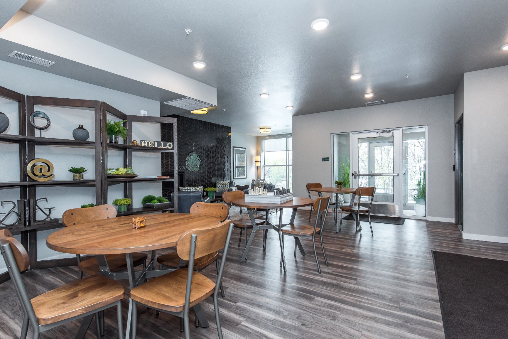 A modern dining room with a wooden table and chairs.