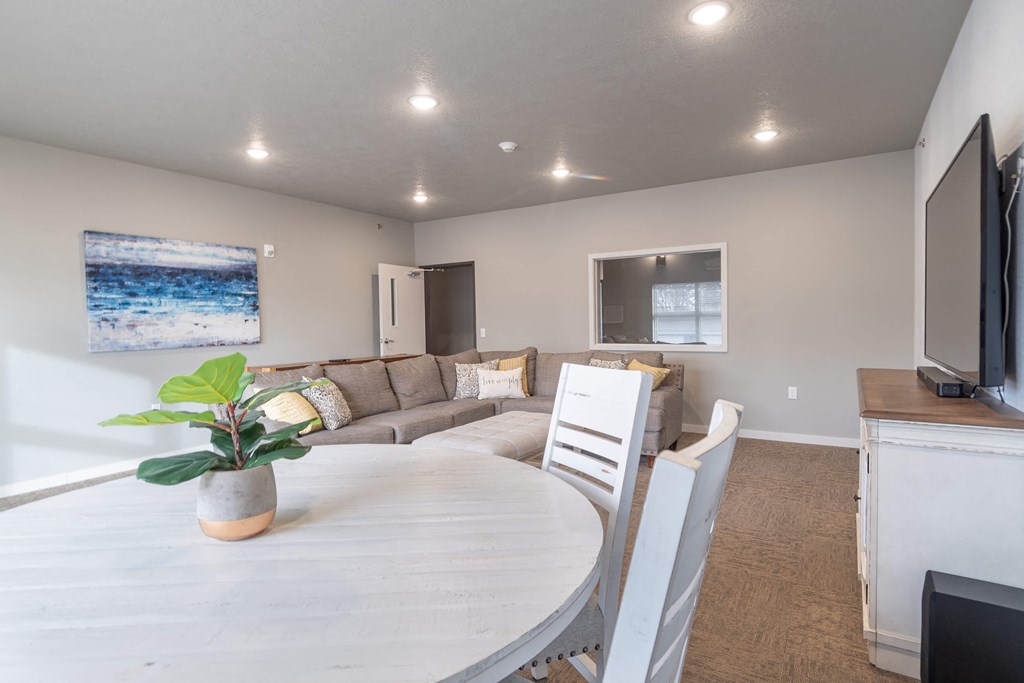 a dining room and living room with a table and a couch