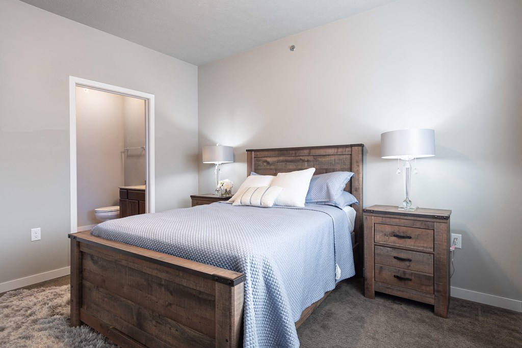 a bedroom with a bed and a mirror