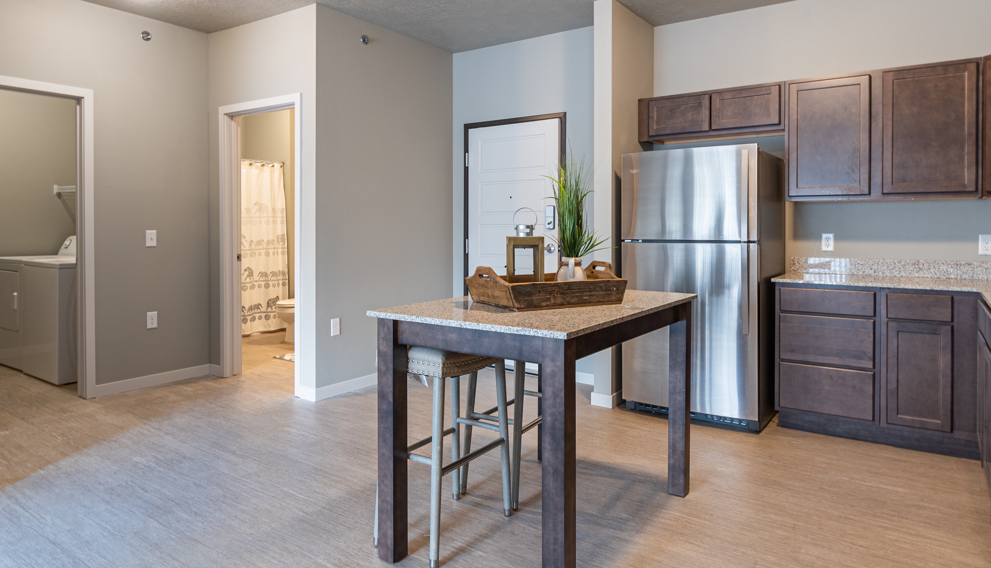 A kitchen with a table and chairs in the middle of the room.