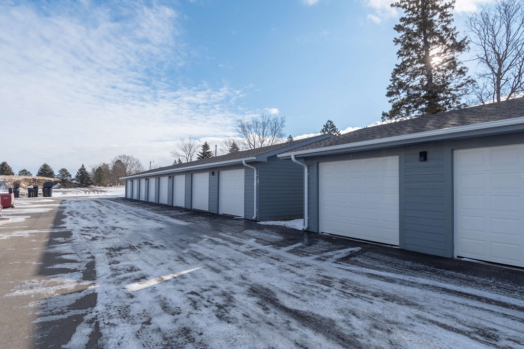 a long row of garages on the side of a building