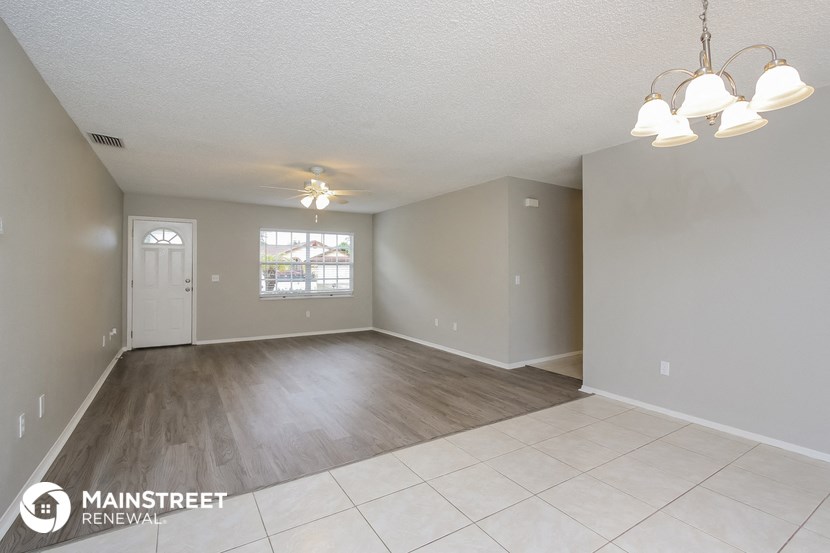 the living room and dining room of an open floor plan