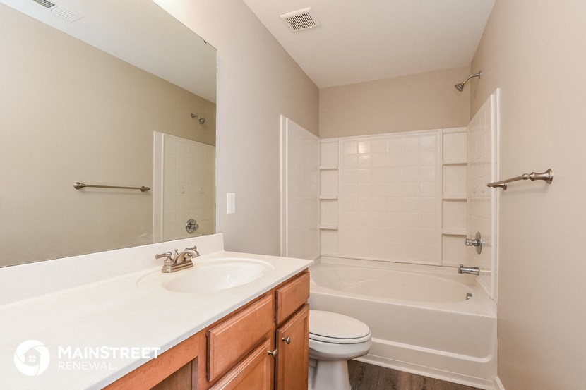 a bathroom with a sink toilet and shower and a tub