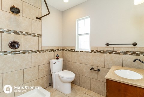 a bathroom with a toilet and a sink and a mirror