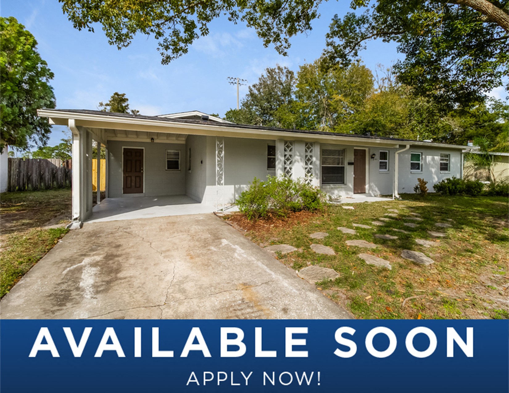 a small white house with a yard and a driveway