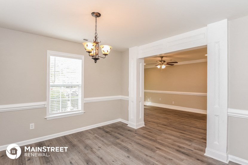 the living room and dining room of a renovated house