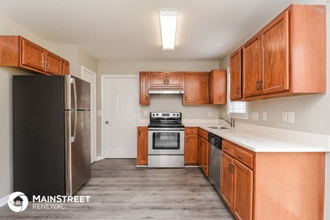 a kitchen with wooden cabinets and stainless steel appliances