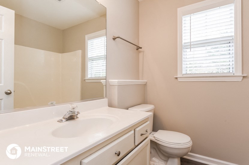 a bathroom with a sink and a toilet and a mirror