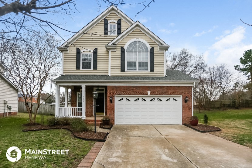 the front of a house with a white garage door