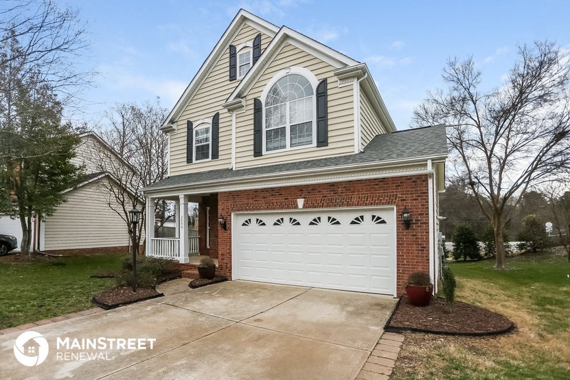 the front of a house with a white garage door