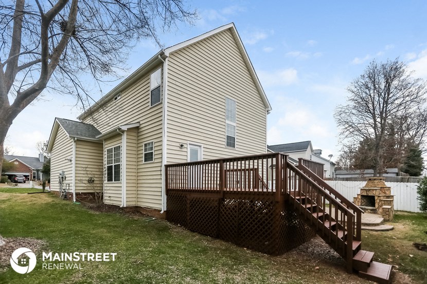 a home with a deck and a wooden fence