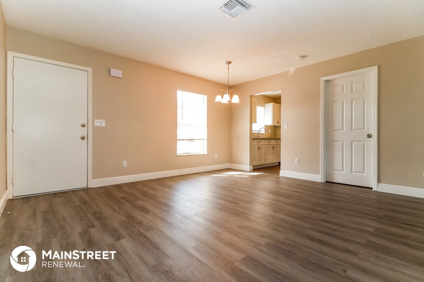 the living room and dining room of an open floor plan