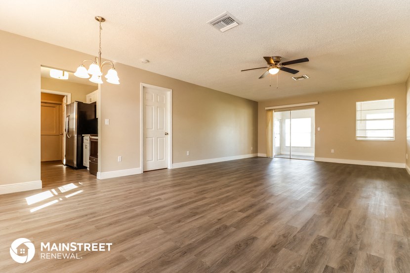 the living room and dining room of an open floor plan