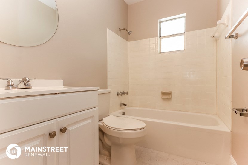 a bathroom with a toilet and a tub and a sink