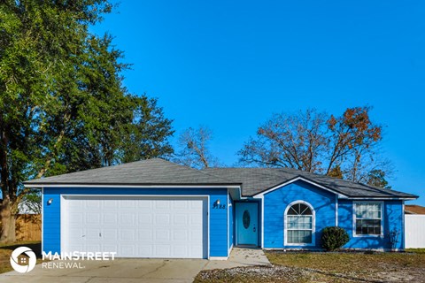 a blue house with a white garage door