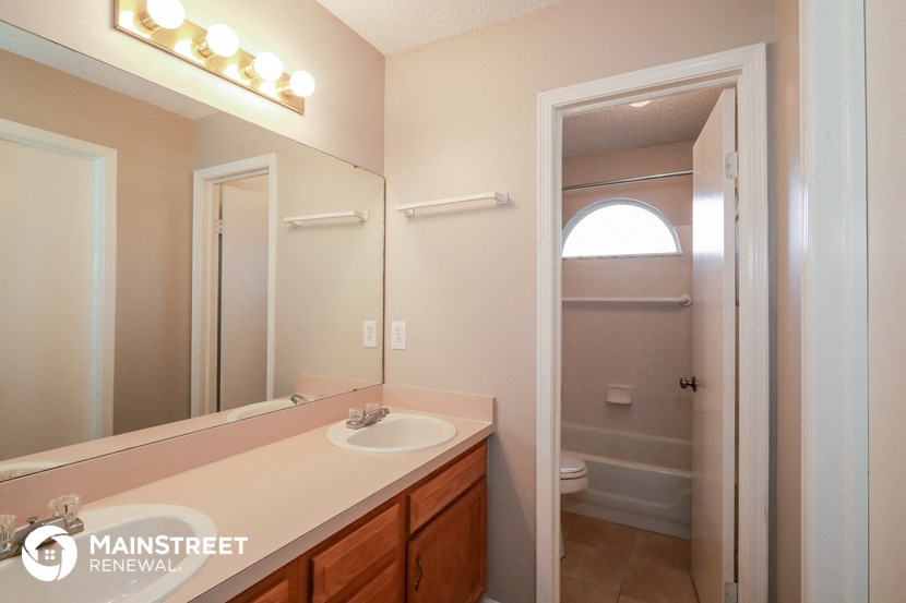 a bathroom with a sink and a mirror and a shower