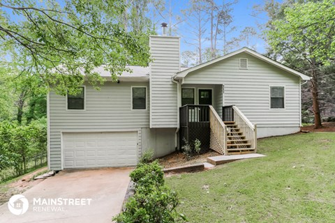 a white house with a driveway and a porch