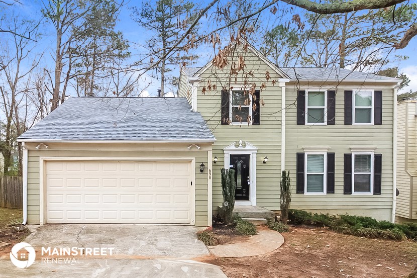 a yellow house with a white garage door