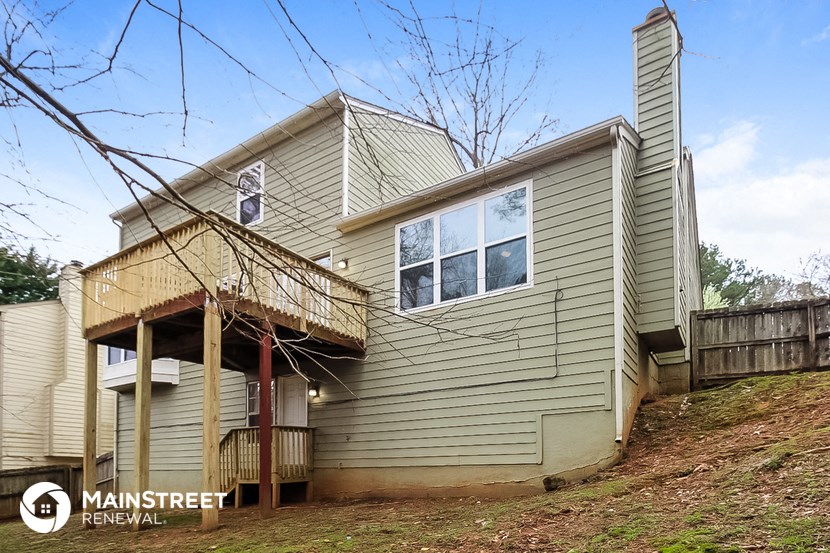the exterior of a house with a deck and a porch