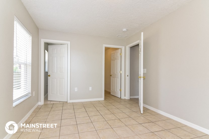 the living room of a home with a tiled floor