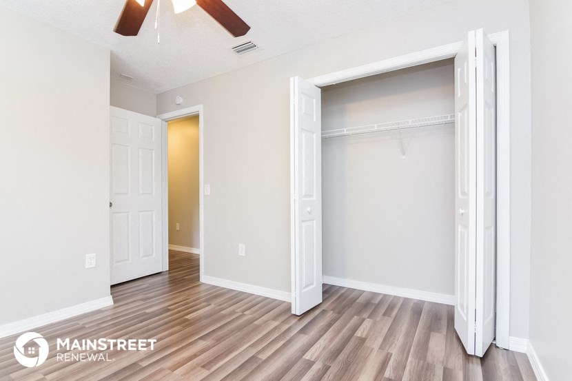 the master bedroom has a large walk in closet and a wood floor