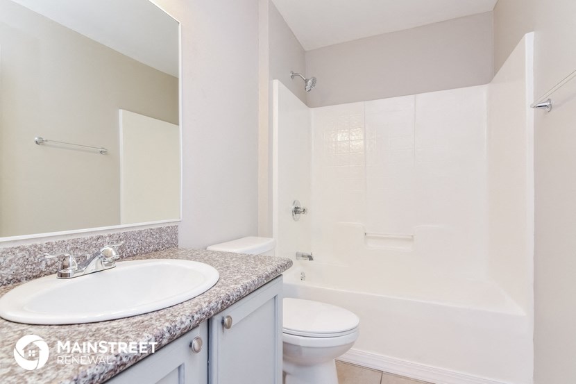 a bathroom with a sink and a toilet and a shower