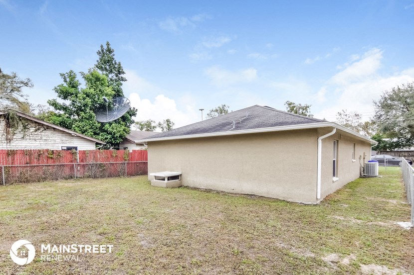 the backyard of a house with a yard and a fence