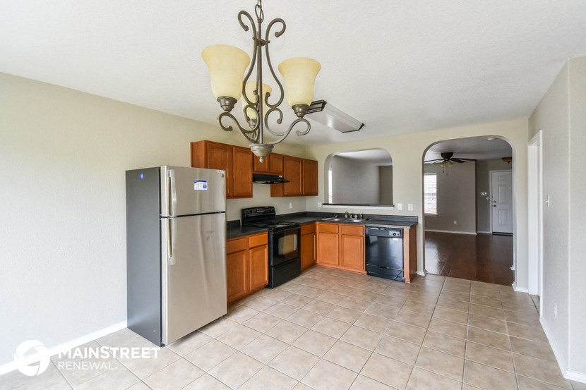 a kitchen with stainless steel appliances and wooden cabinets