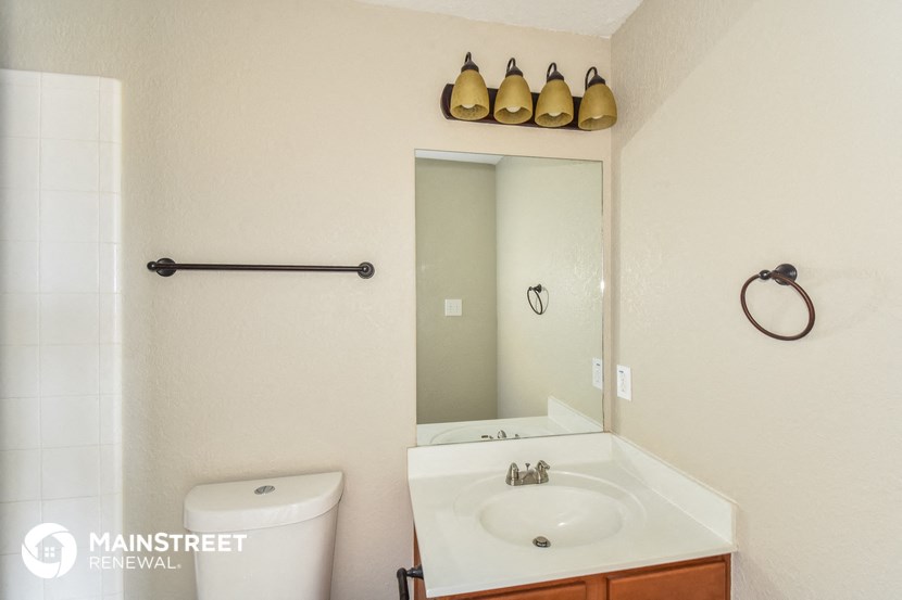 a bathroom with a sink and a toilet and a mirror