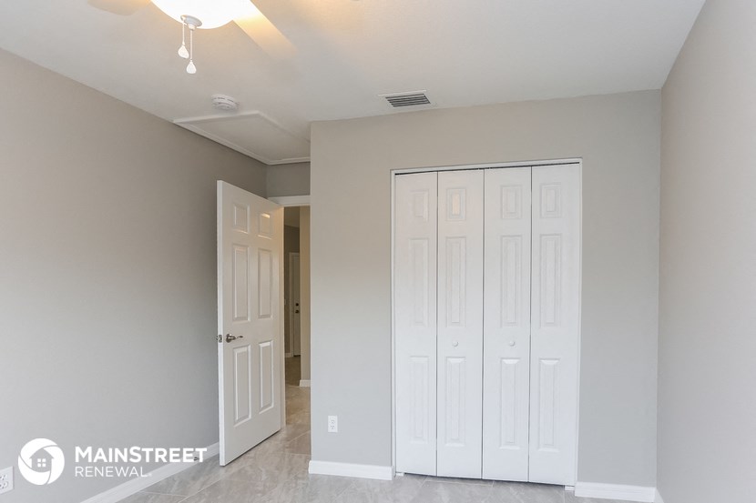 a bedroom with two closets and a door to a hallway