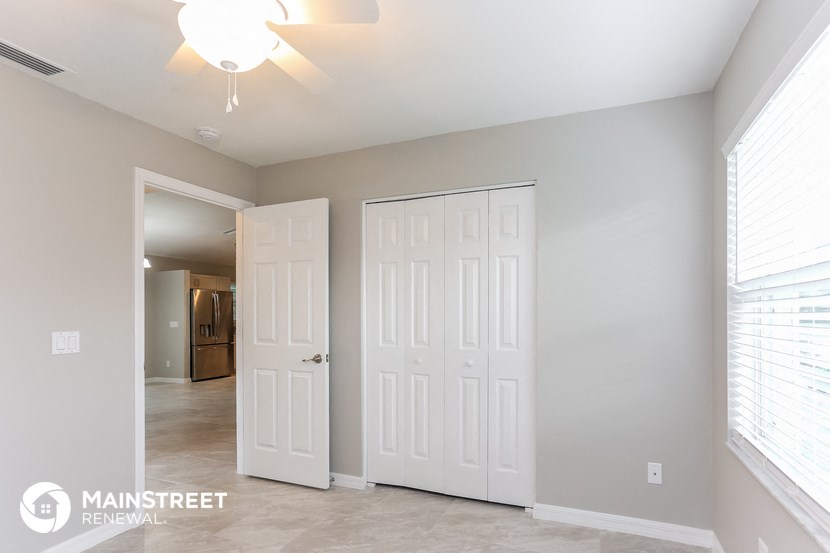 a master bedroom with two closets and a door to a hallway