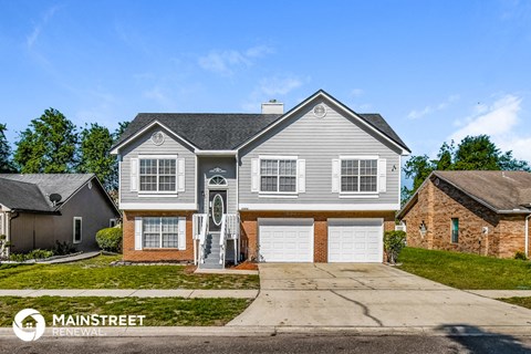 a house with two garage doors and a driveway