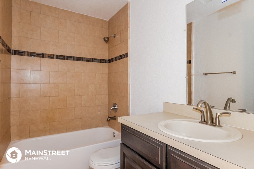 a bathroom with a sink and a bath tub and a mirror