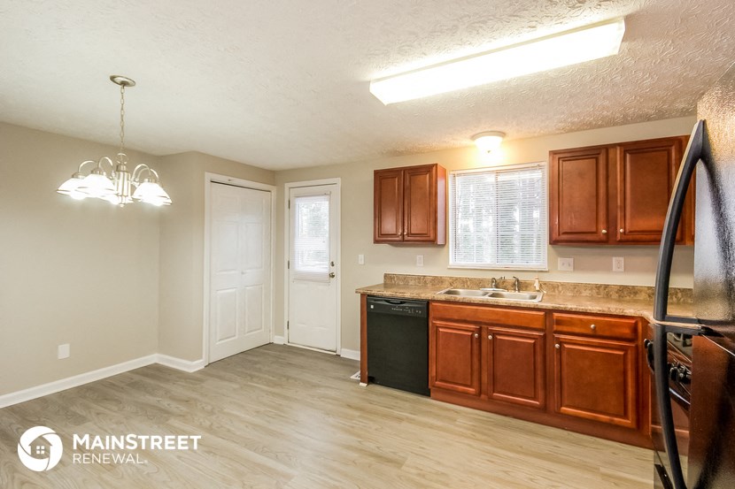 a kitchen with wooden cabinets and a sink and a counter top